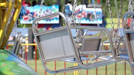 metal seat of carousel is swaying