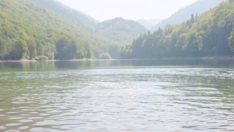 man splashing in a mountain lake