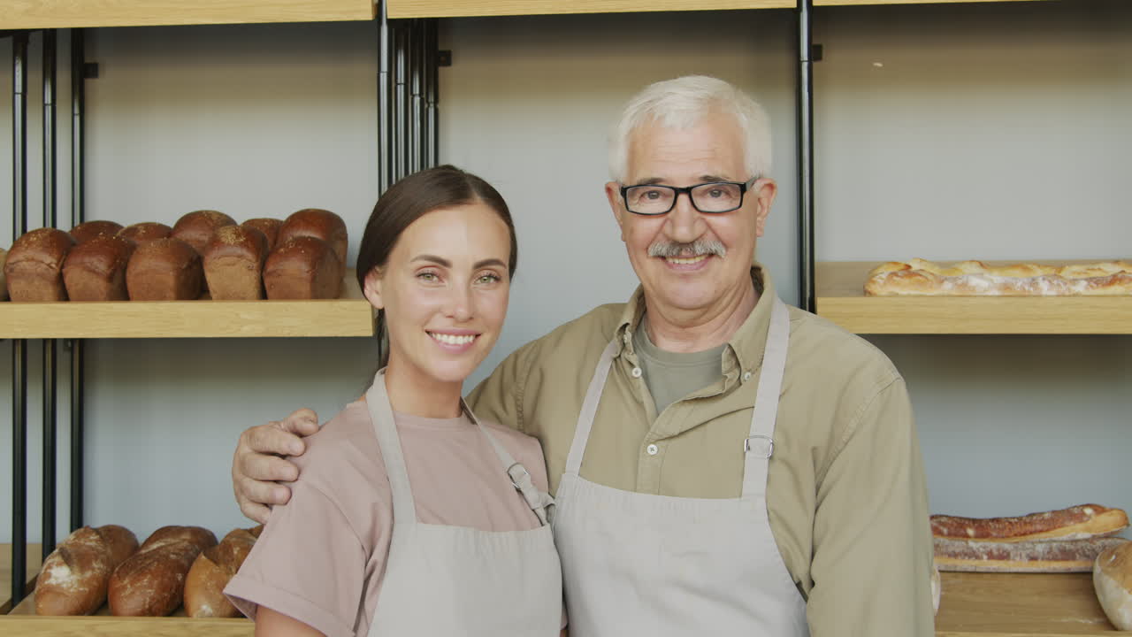 Young and Elderly Bakery Employees Posing