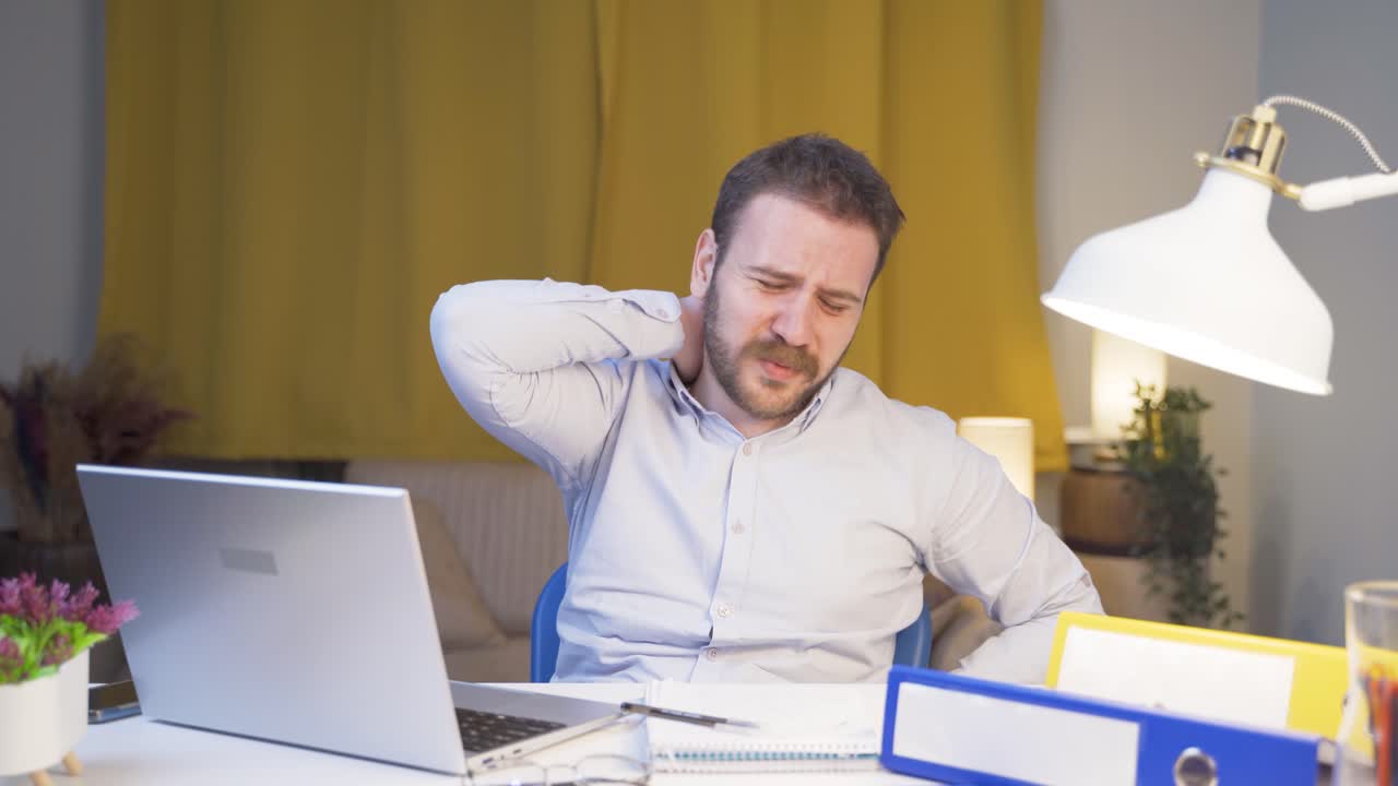 Home office worker man has neck pain.