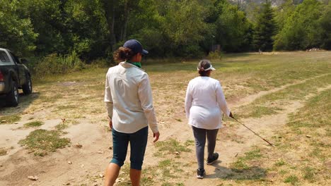 A-Blind-Woman-Walks-With-A-Cane-Through-A-Natural-Area-With-A-Guide-Helping-Her-Explore-The-Wilderness-6