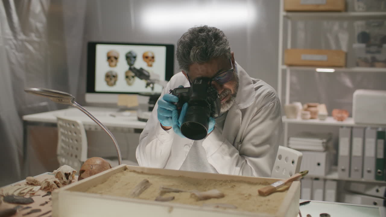 Senior Archaeologist Photographing Excavated Artifacts in Laboratory