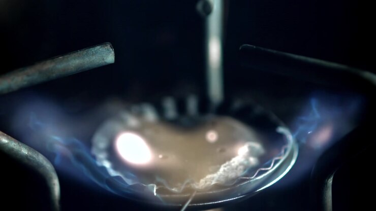 Gas Stove Burner Ignites with Blue Flames in Slow Motion