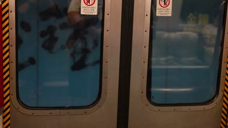 person walking past subway train in hong kong