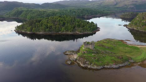 a drone shot of castle, tioram a ruined castle that sits on the tidal island eilean, tioram in loch, moidart, lochaber, highland, scotland