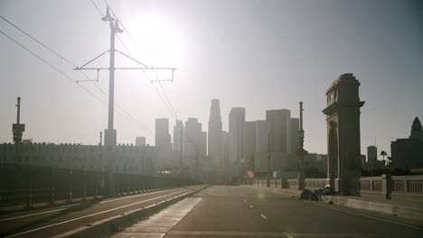 downtown los angeles cityscape from a bridge with tram tracks