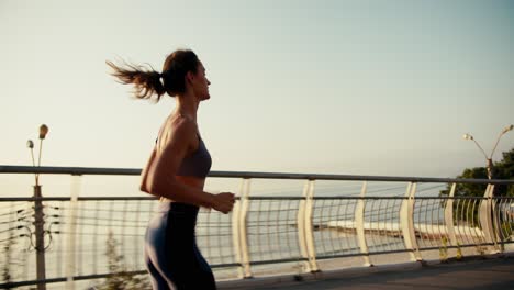 top view of a happy athletic girl in a sports summer uniform who is jogging in the morning