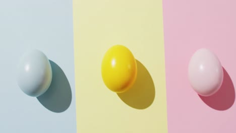 Close-up-of-three-colorful-easter-eggs-on-colorful-background