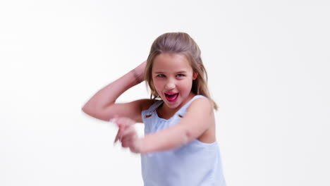 girl walks into shot and poses against white studio background