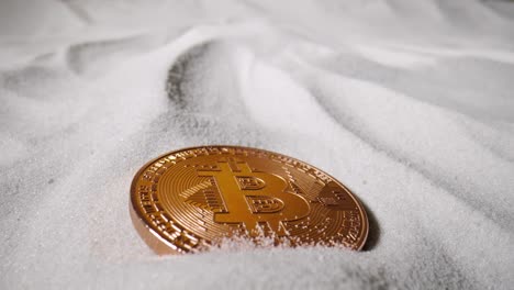 bitcoin coin on sand