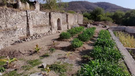 aerial: ex hacienda de san jacinto ixtoluca, rocky wall during the day in la mezquitera, morelos, mexico, dolly out drone shot