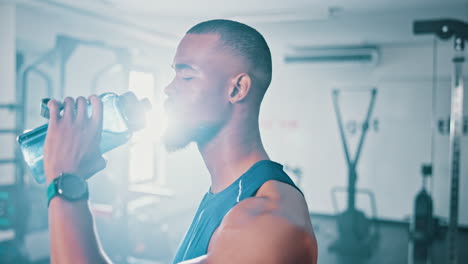 man drinking water after workout