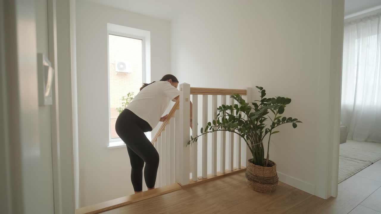 una hermosa mujer embarazada ordenando su casa, ocupada en las tareas domésticas. la escena captura la vida doméstica, la maternidad y el equilibrio de la rutina y la preparación durante el embarazo