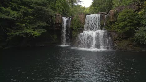 man jumps into waterfall