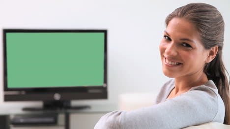 brunette woman watching the television