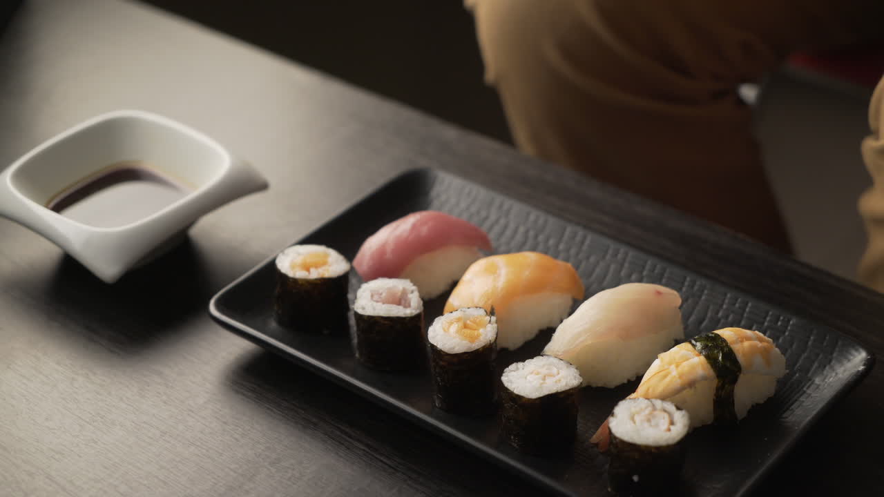 Dinner at a Japanese restaurant. Eating sushi.