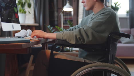 woman in wheelchair working on computer