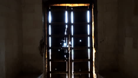 we see the main door of zinciriye madrasa and the light beams entering from the outside and the camera tilts down to scan the door