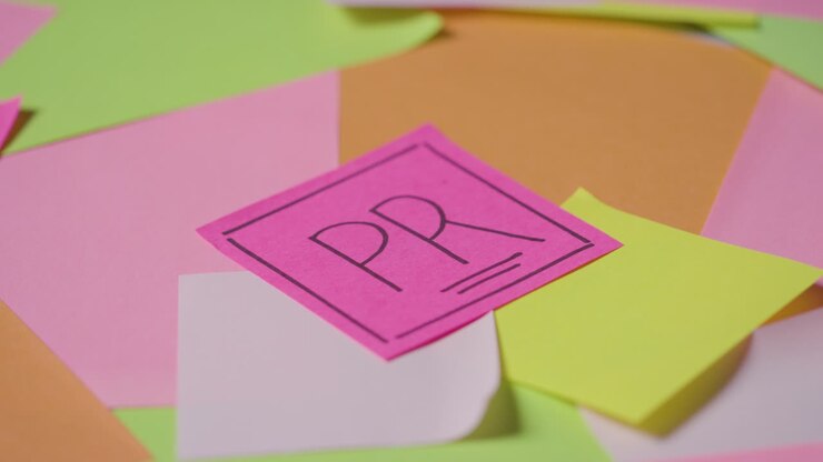 Business Concept Of Revolving Sticky Notes With PR Written On Top Note 1