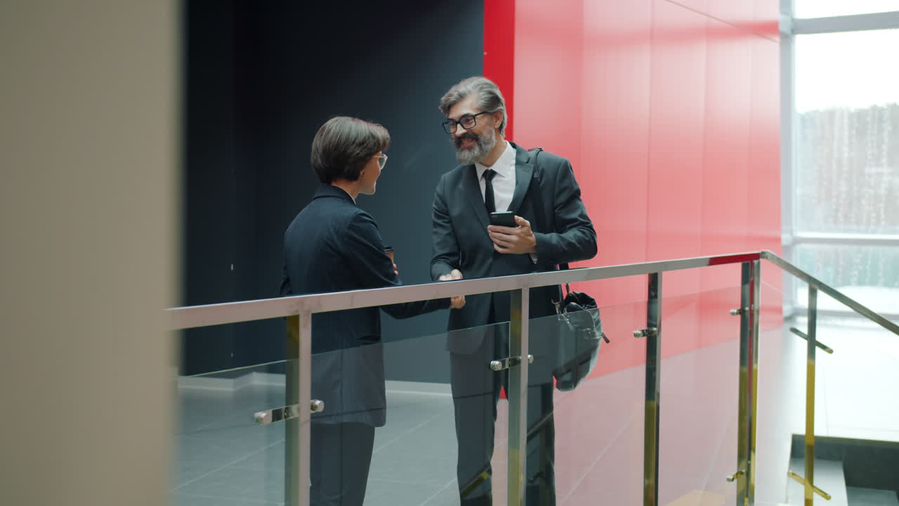 Businesspeople Meeting in Office Corridor
