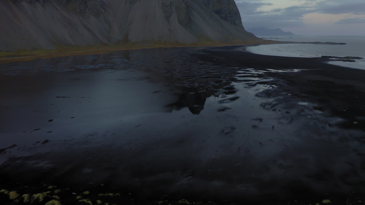 Aerial: Vestrahorn mountain in Stokksnes beach. Reveal shot