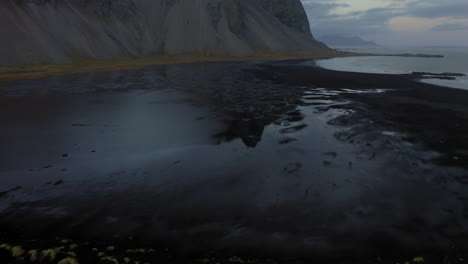 aerial: vestrahorn mountain in stokksnes beach. reveal shot