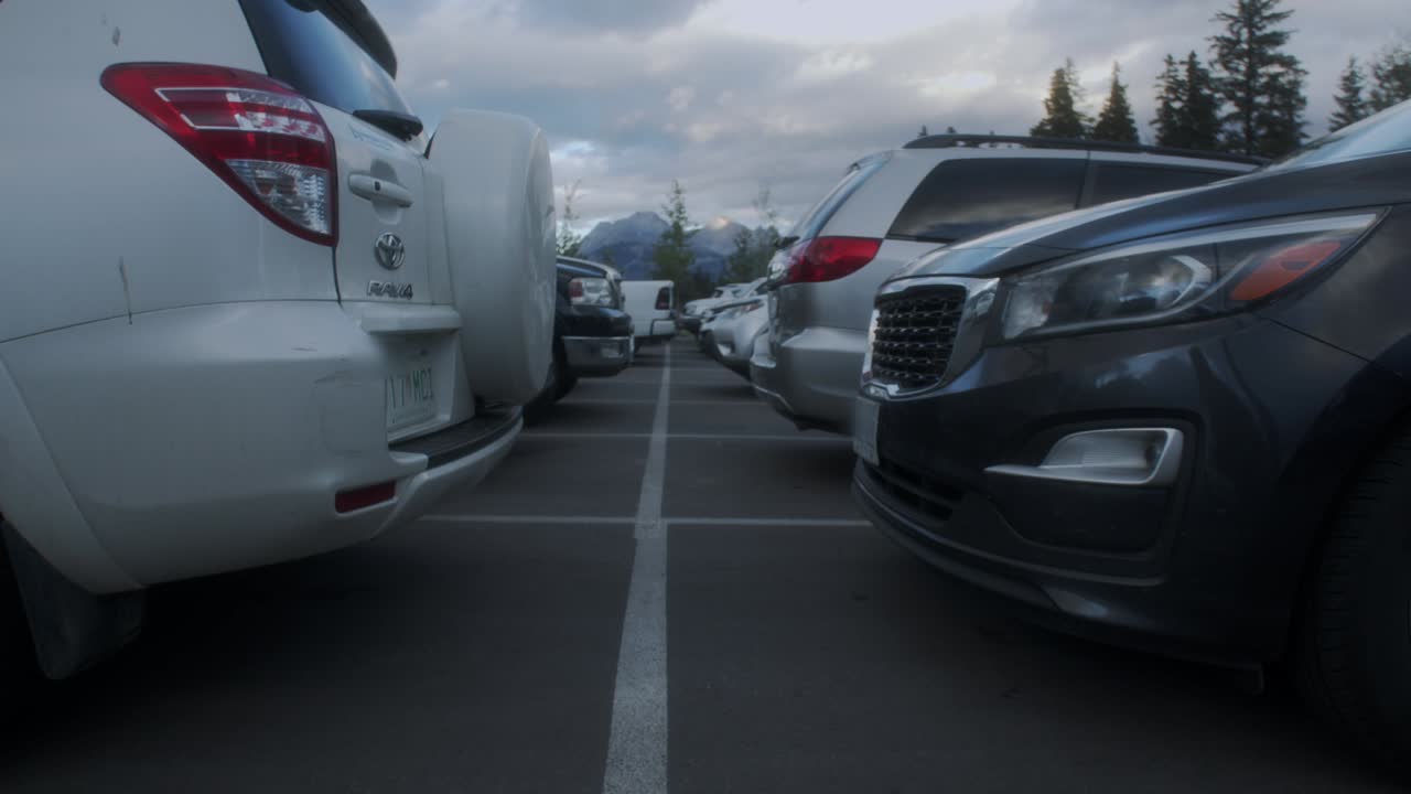 Parking lot view from between cars passing trough