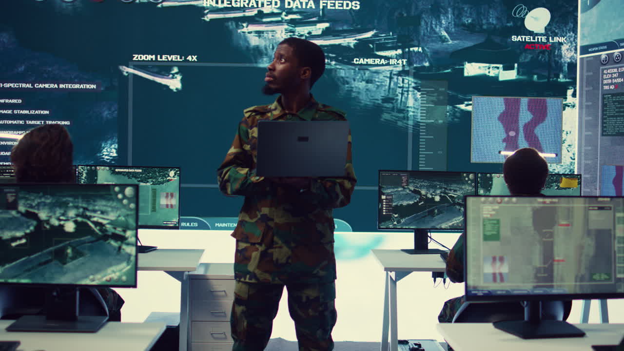 Infantry unit leader examines big data on a screen in military monitoring room