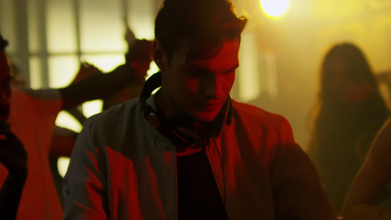 Man in Headphones Dancing at Nightclub Party