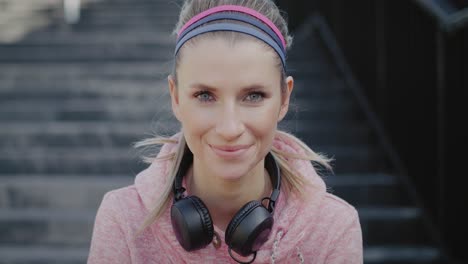 portrait of smiling woman after hard jogging training