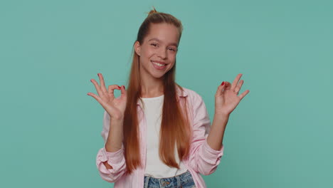 lovely girl child looking approvingly at camera showing ok gesture, like sign positive, approve good