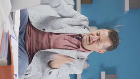 Vertical-video-of-Home-office-worker-old-man-getting-angry.