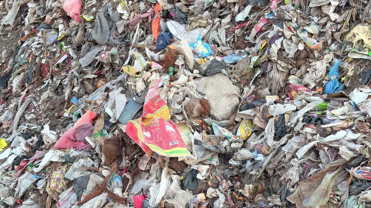 static shot of a pile of garbage at the dump yard, microplastic pollution