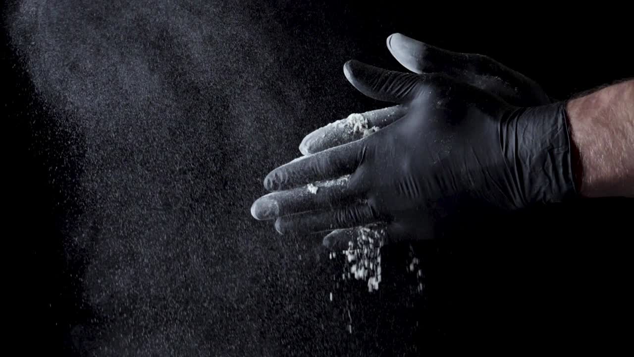 Chef in Black Gloves Dusting Flour