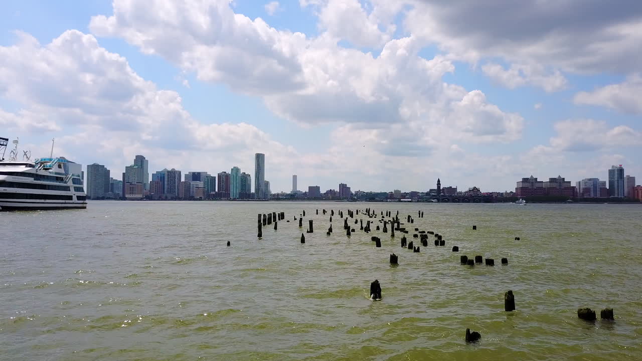 Drone Zoom In Broken Pier in Hudson River - New York City, Jersey City Background, Sunny Day