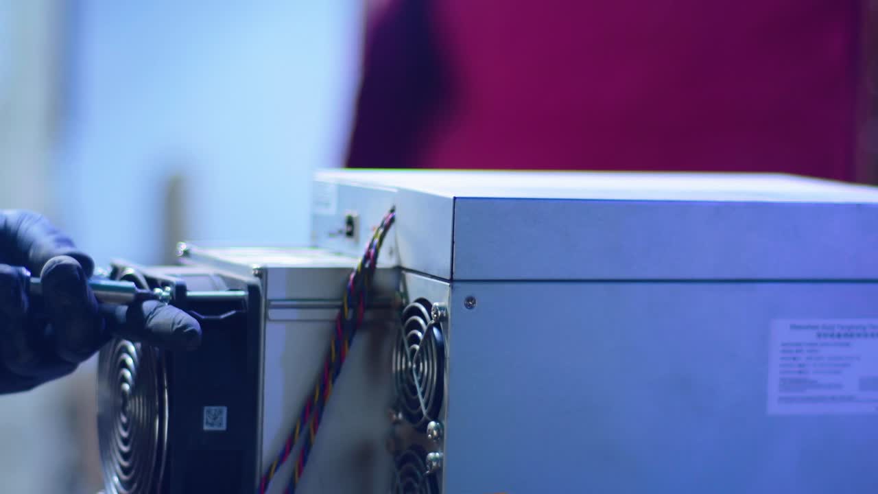 technician repairing crucial cooling components and power connections of crypto hardware. Bitcoin and cryptocurrency miner, data mining rig. GPUs