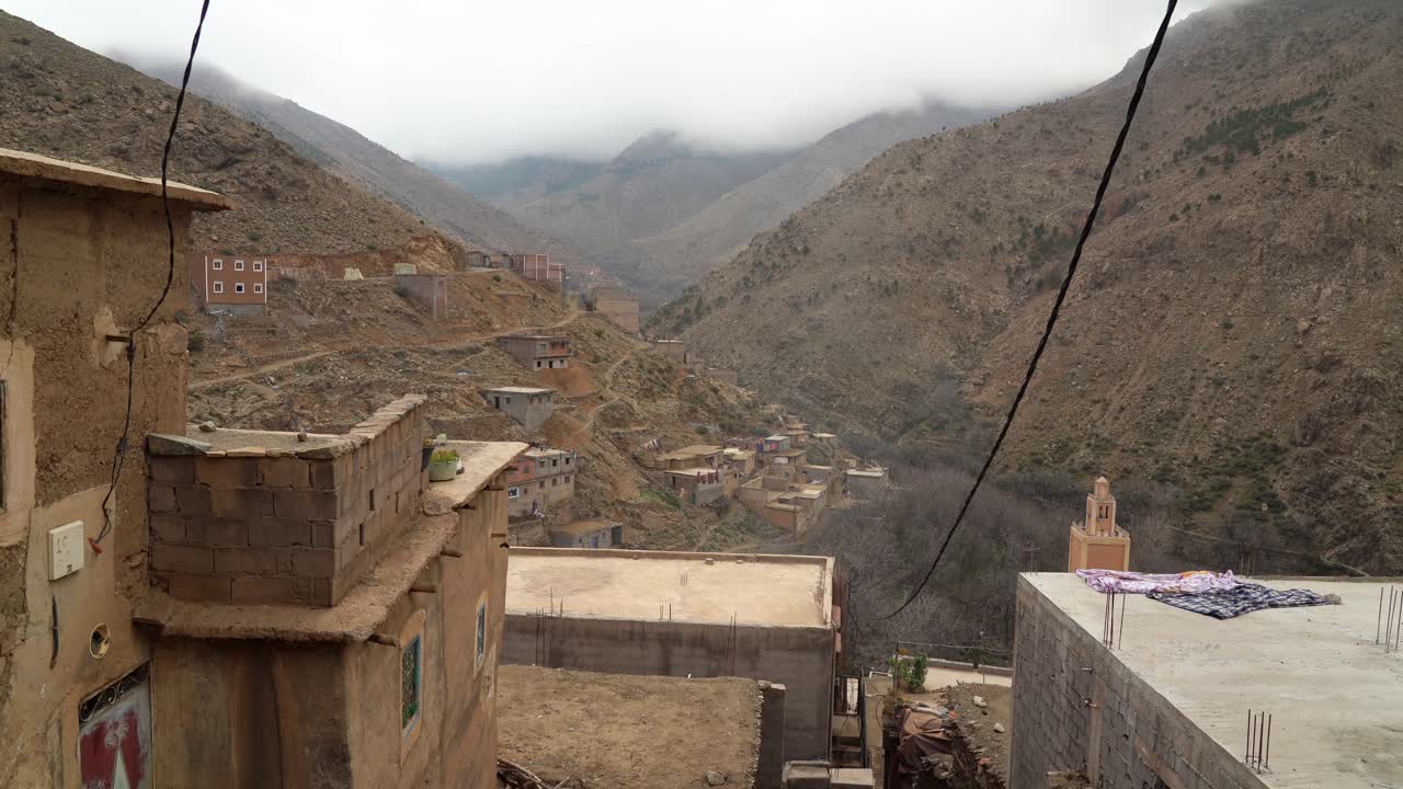 The cobbled streets of the mountain village wind through clusters of houses, with Toubkal's snowy peaks visible at the end of every pathway in Morocco