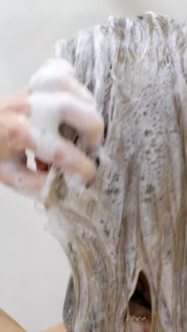 young slim woman taking a shower and washing her hair.