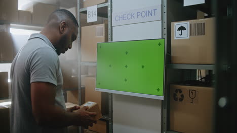 warehouse worker inspecting package at check point