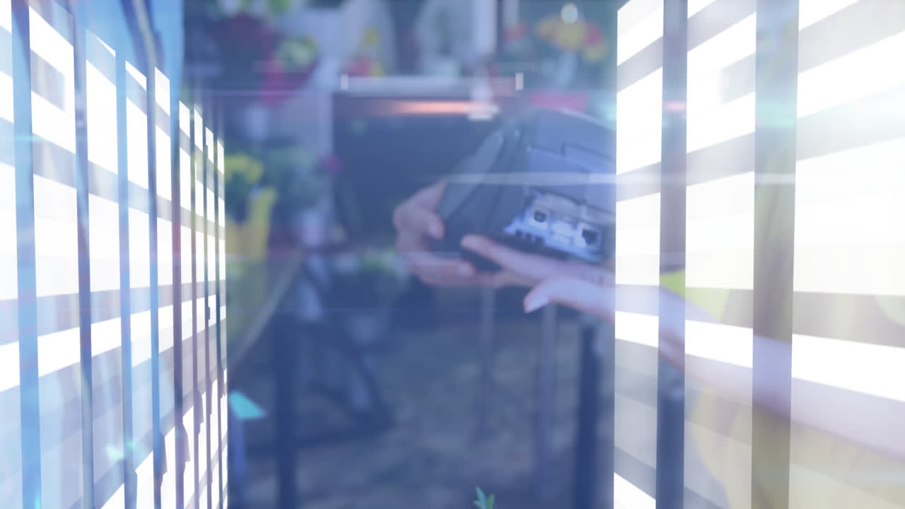 Animation of light spots over caucasian woman paying with credit card