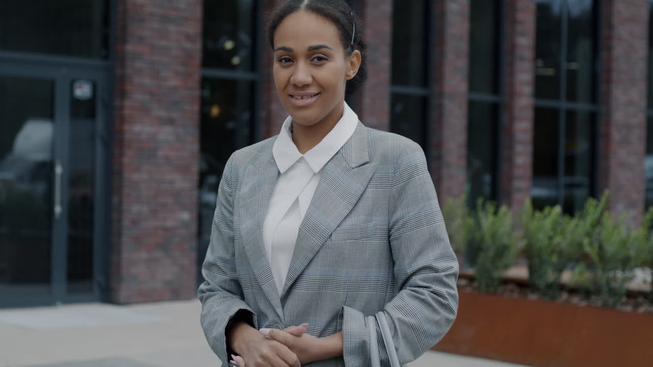 Businesswoman in front of a modern brick building