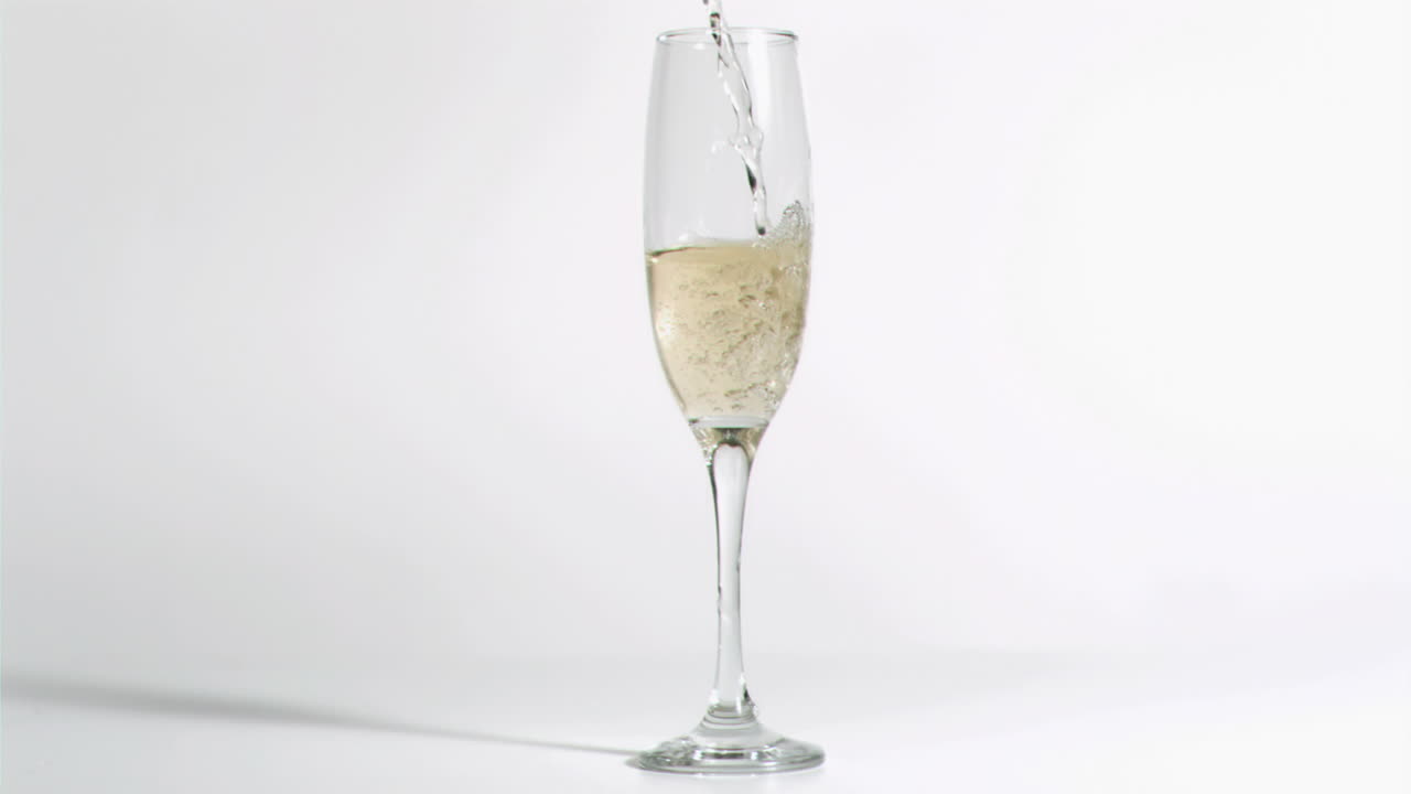 Glass filled in super slow motion with champagne