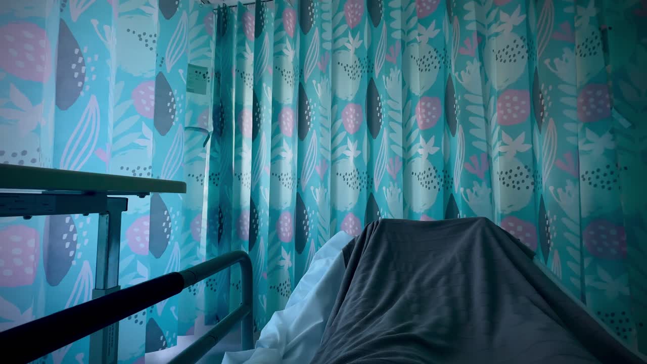 Hospital bed feet under blanket curtain dark still ward medical Perth WA