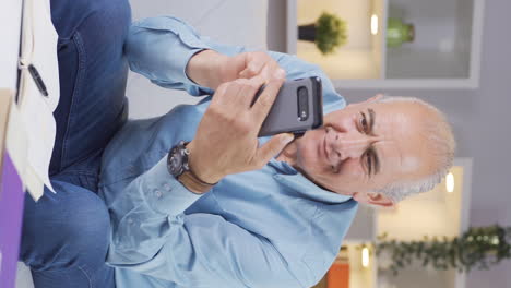 Vertical-video-of-The-old-man-in-love-gets-excited-at-the-incoming-phone-message.