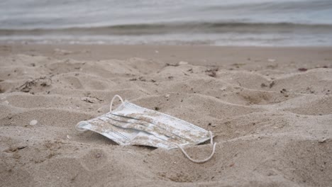 discarded mask on the shore.