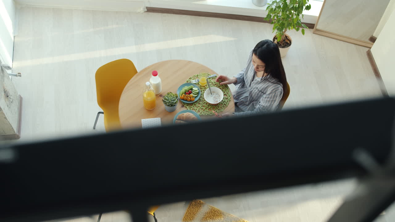 Woman having breakfast in a bright apartment