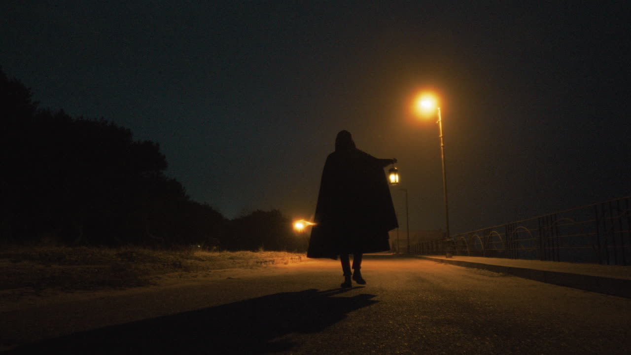 A Mysterious Man Walks In A Dark Street On Halloween Ghost Night