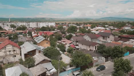 a small village with colorful rooftops surrounded by lush greenery on a sunny day, aerial view