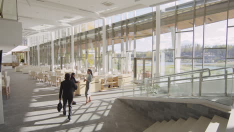 business professionals in a modern corporate building lobby with lake view