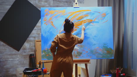 artist painting on canvas